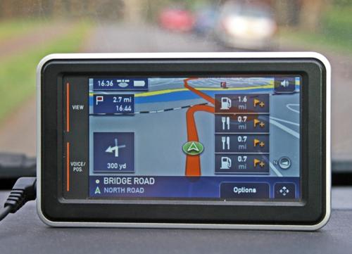 A satellite navigation system showing a route on a dashboard